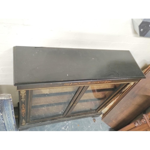 582 - Victorian ebonised and inlaid gilt metal mounted cabinet enclosed by pair of glazed doors on plinth ... 