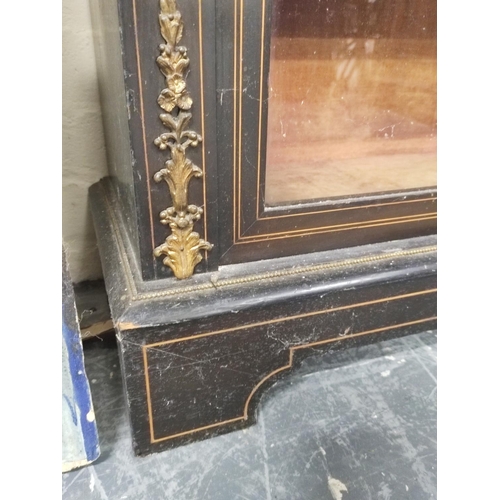 582 - Victorian ebonised and inlaid gilt metal mounted cabinet enclosed by pair of glazed doors on plinth ... 