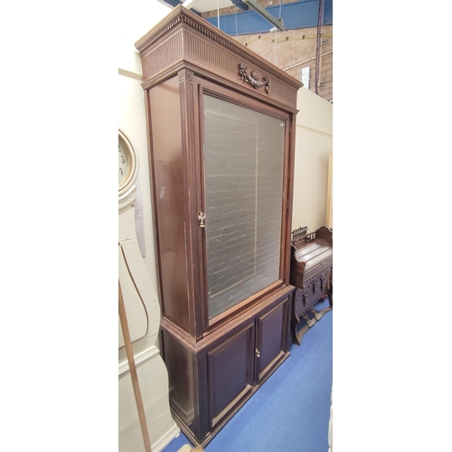 583 - Mahogany floor standing display cabinet, the baize lined interior enclosed by single door over pair ... 