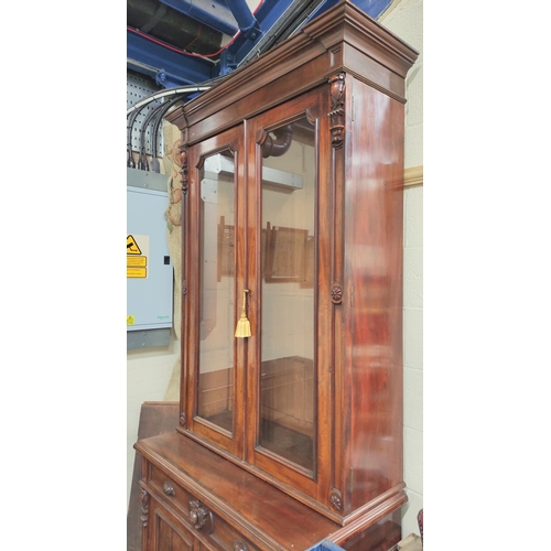 584 - Victorian carved mahogany cabinet bookcase, the upper section enclosed by pair of glazed doors over ... 