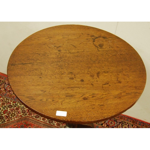307 - George III oak tripod table, the circular top on a turned column and tripod supports, 75cm high and ... 