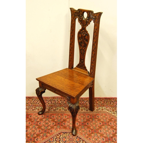 308 - Early 20th century carved oak hall chair, the shaped top above a fiddle-shaped back rest carved with... 