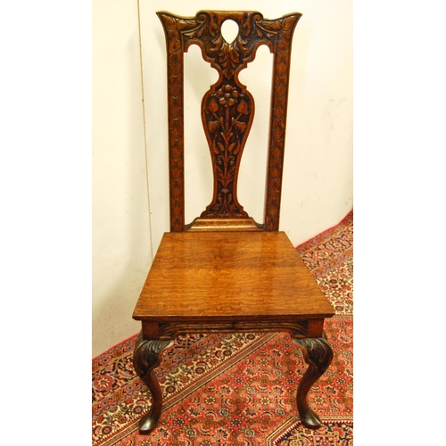 308 - Early 20th century carved oak hall chair, the shaped top above a fiddle-shaped back rest carved with... 