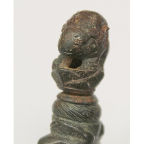 290 - Eastern bronze weight or toggle with ram's head finial, moulded figure of buddha as a child and fist... 