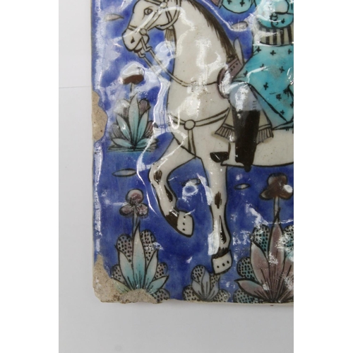 462 - Persian glazed tile or panel decorated in a typical Qajar manner with a figure on horseback hunting ... 