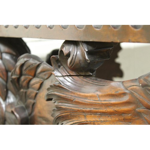 562 - Impressive walnut console table base on scroll supports profusely carved with grotesque birds at eac... 