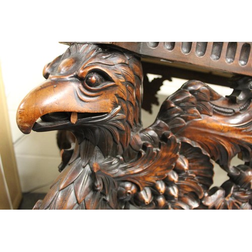 562 - Impressive walnut console table base on scroll supports profusely carved with grotesque birds at eac... 