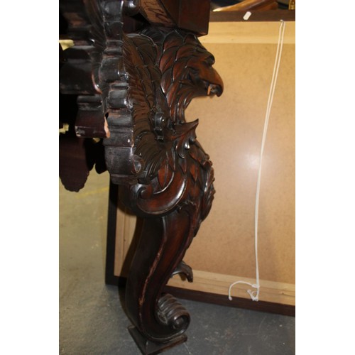 562 - Impressive walnut console table base on scroll supports profusely carved with grotesque birds at eac... 