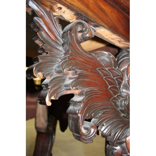 562 - Impressive walnut console table base on scroll supports profusely carved with grotesque birds at eac... 