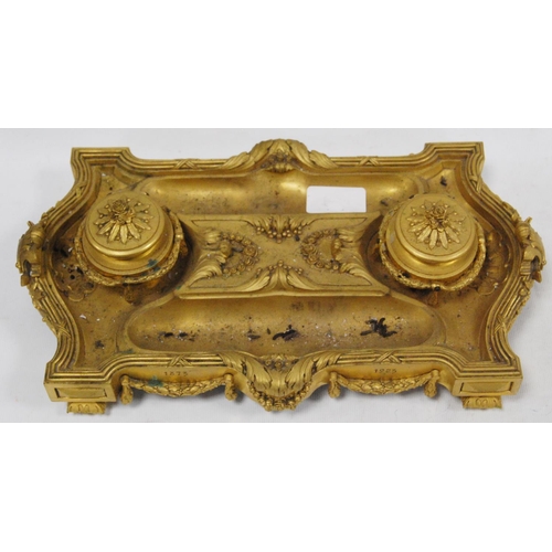 122 - Gilt metal desk stand with two integral inkwells, with two open quill wells and applied classical-st... 