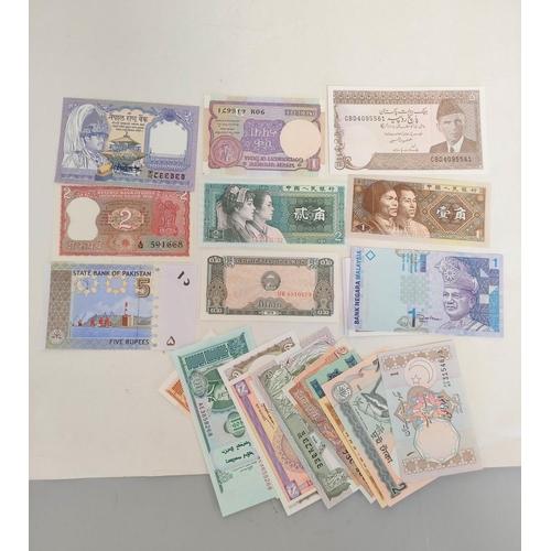 127 - Banknotes- Pristine world banknotes predominantly comprising of Asian issues and dating from the 197... 