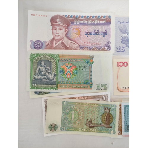 128 - Banknotes- Pristine world banknotes predominantly comprising of Asian issues. To include issues a Bu... 