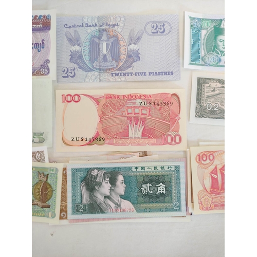 128 - Banknotes- Pristine world banknotes predominantly comprising of Asian issues. To include issues a Bu... 