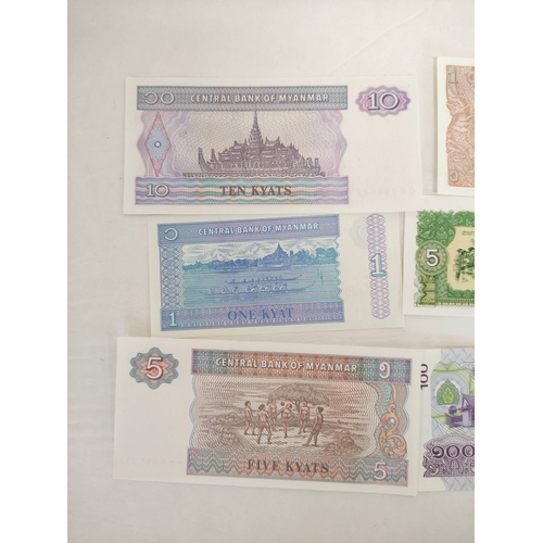 128 - Banknotes- Pristine world banknotes predominantly comprising of Asian issues. To include issues a Bu... 