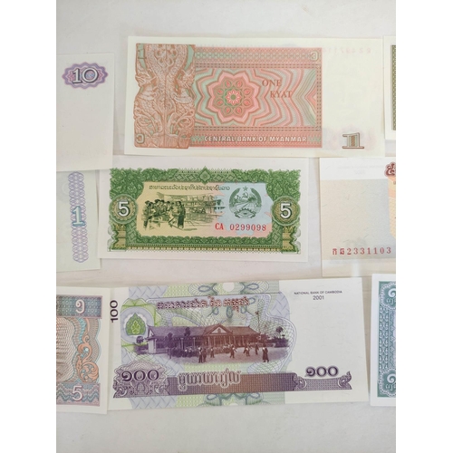 128 - Banknotes- Pristine world banknotes predominantly comprising of Asian issues. To include issues a Bu... 