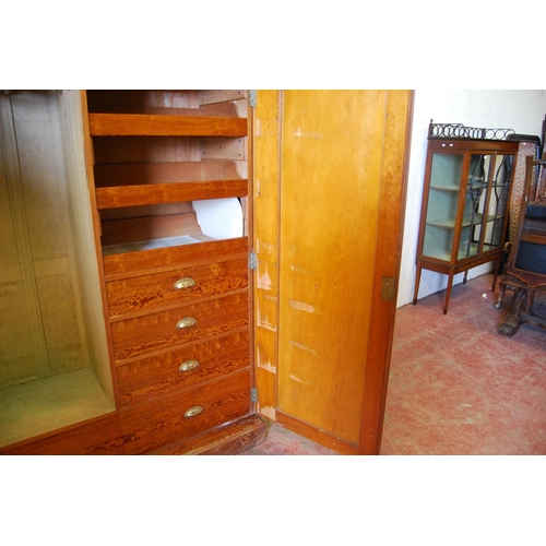 314 - Victorian pitch pine wardrobe, the shaped cornice above two doors enclosing fitted drawers and hangi... 