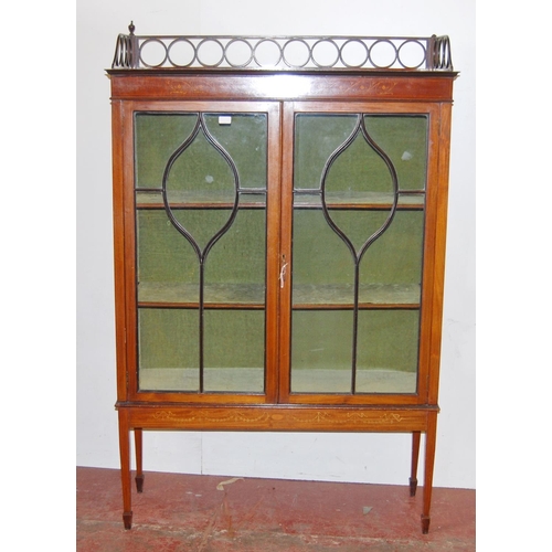 317 - Edwardian inlaid mahogany display cabinet, with a concentric pierced pediment top above an inlaid fr... 