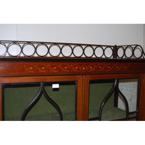 317 - Edwardian inlaid mahogany display cabinet, with a concentric pierced pediment top above an inlaid fr... 