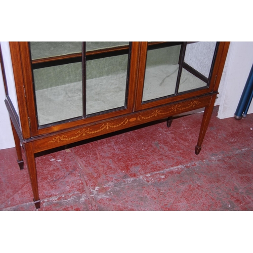 317 - Edwardian inlaid mahogany display cabinet, with a concentric pierced pediment top above an inlaid fr... 