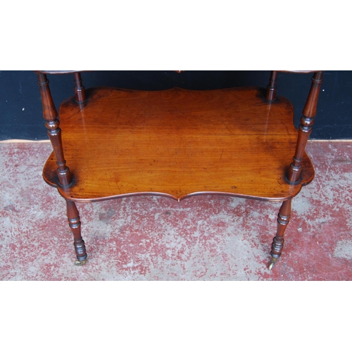 330 - 19th century mahogany window table, with two shaped tiers, on turned supports with brass castors, 75... 