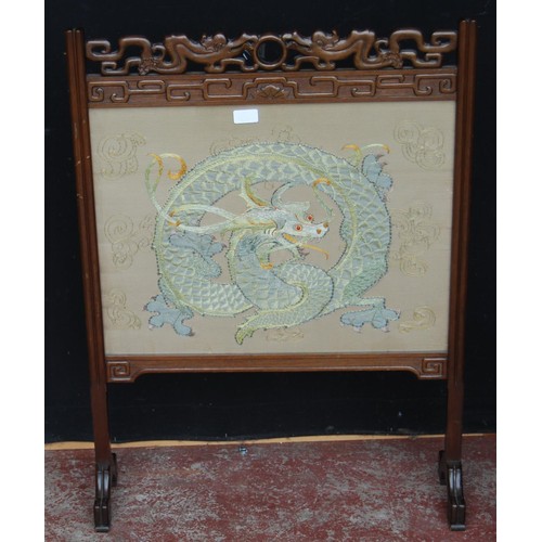 329 - Chinese hardwood firescreen, decorated with an embroidered panel of a dragon, beneath glass, 86cm hi... 