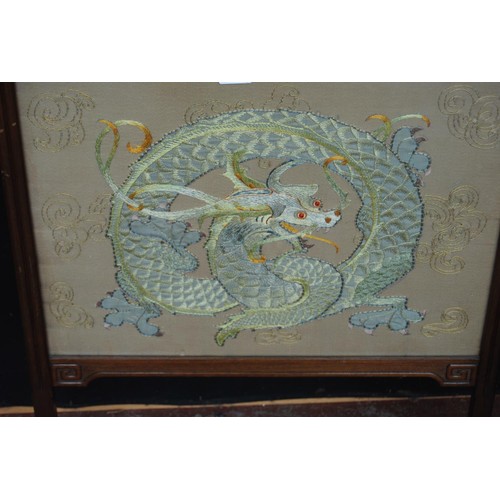 329 - Chinese hardwood firescreen, decorated with an embroidered panel of a dragon, beneath glass, 86cm hi... 
