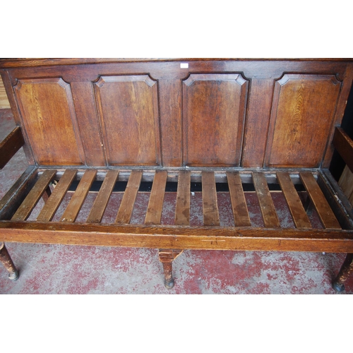 321 - Early 19th century oak hall bench, with a four-section panelled back above a later slatted seat, wit... 