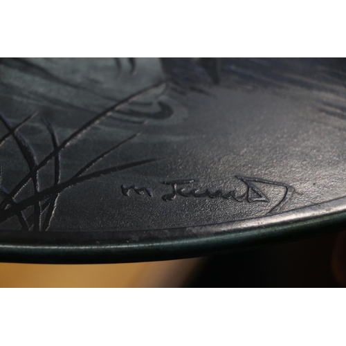 18 - Ceramic plaque with cameo style decoration depicting swans swimming, 51cm wide.