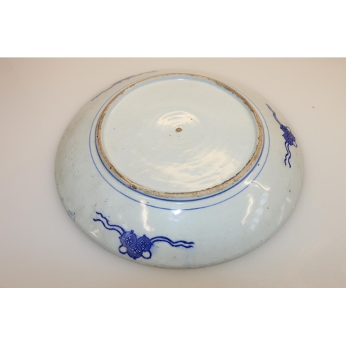 24 - Oriental blue and white floral decorated dish, 30cm diameter.