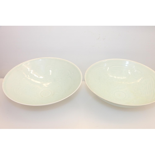 39 - Pair of oriental celadon ground bowls, 21cm.
