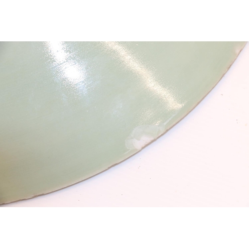 47 - Large oriental celadon ground shallow dish, 36cm.