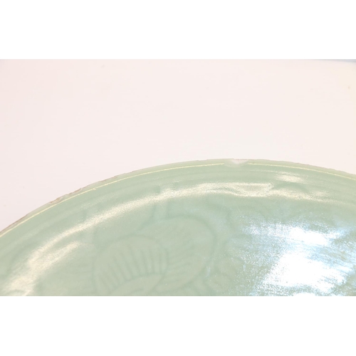 47 - Large oriental celadon ground shallow dish, 36cm.