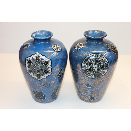 48 - Pair of Fenton blue ground vases decorated with floral gilt pattern and geometric roundels, 21cm.