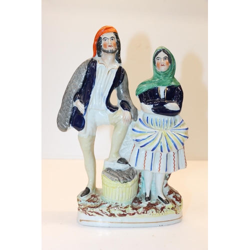 53 - Staffordshire model of a standing couple, 23cm.