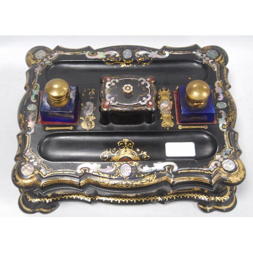 134 - Victorian black papier mâché gilt and mother of pearl desk stand with integral stamp box and pen wel... 