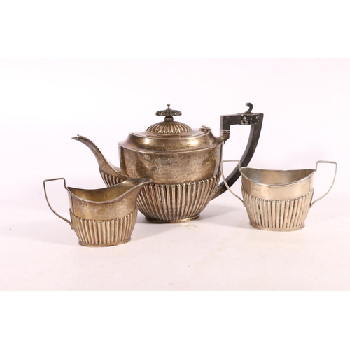 460 - George V silver three-piece tea set with half gadrooned body, the teapot with inscription 