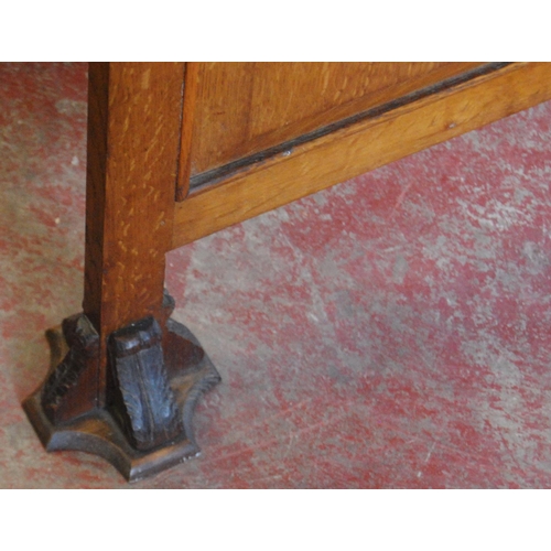 347 - English School: carved oak fire screen, carved with a floral cartouche to the centre, flanked by flo... 