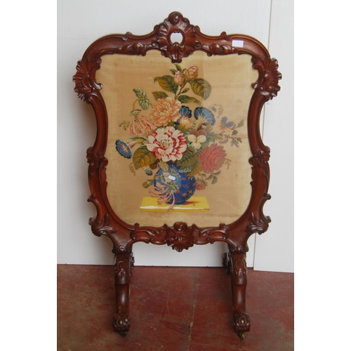 353 - Victorian mahogany fire screen, with a needlepoint panel to the centre depicting flowers in a vase, ... 