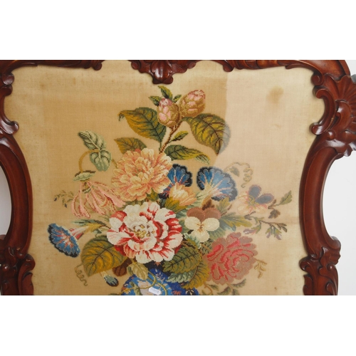 353 - Victorian mahogany fire screen, with a needlepoint panel to the centre depicting flowers in a vase, ... 