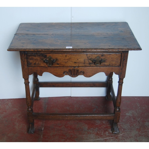 368 - George III oak lowboy, the rectangular plank top above a long drawer and shaped apron, on turned sup... 