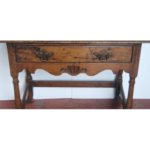 368 - George III oak lowboy, the rectangular plank top above a long drawer and shaped apron, on turned sup... 