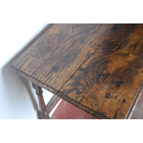 368 - George III oak lowboy, the rectangular plank top above a long drawer and shaped apron, on turned sup... 