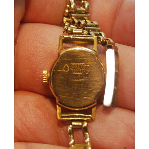 38 - Lady's gold watch, '750', on 9ct gold bracelet, 7.7g without movement.