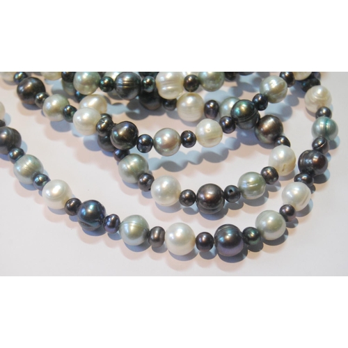 40 - Long pearl necklace, blue, black and other hues.