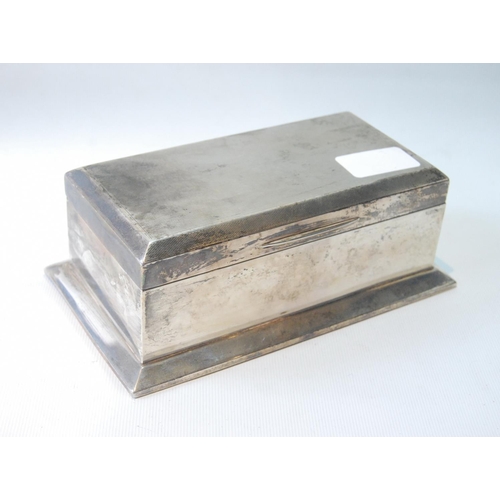 41 - Silver cigarette box with engine turned top, on spreading base, Birmingham 1927, 18.5cm x 10.5cm.