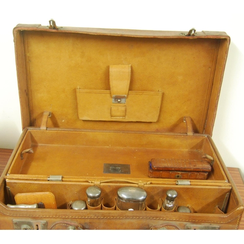 50 - Pigskin dressing case with five silver-mounted glass bottles and other fittings, 1905, inscribed pla... 
