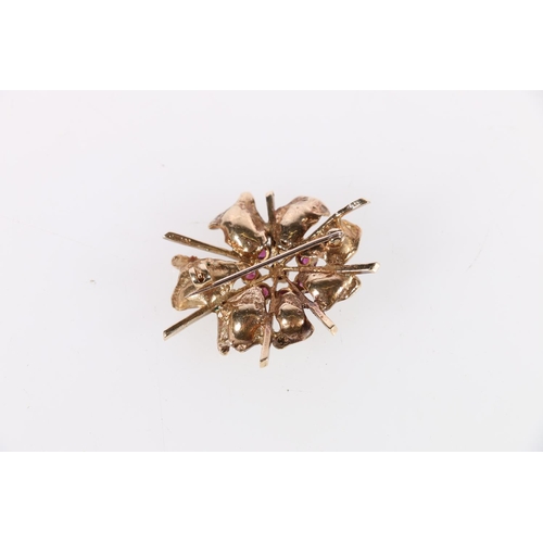 123 - 9ct gold floral design brooch, the flowerhead set with eight rubies, 10.2g.