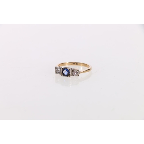 142 - Gold sapphire and diamond three stone ring in the Art Deco manner, the central faceted sapphire flan... 