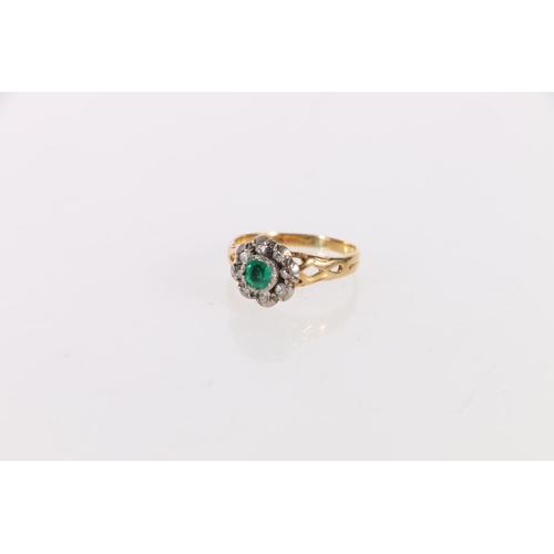 145 - Unhallmarked yellow and white metal dress ring set with central faceted emerald green stone encircle... 