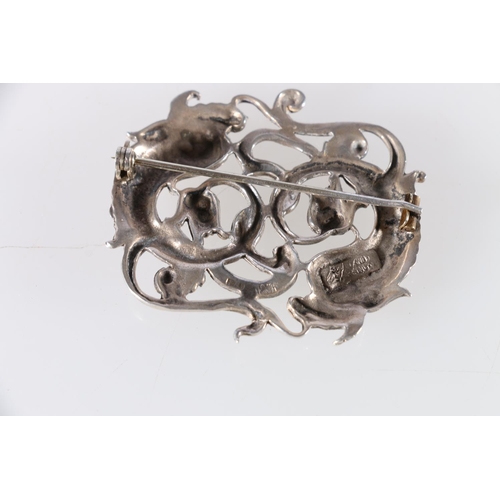 149 - Scottish Arts & Crafts style silver brooch modelled as two fish in a scrolling frame, makers mar... 